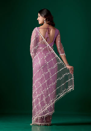 Purple net saree with intricate cutdana work by Kanyaari, featuring elegant drape and detailed embellishments.
