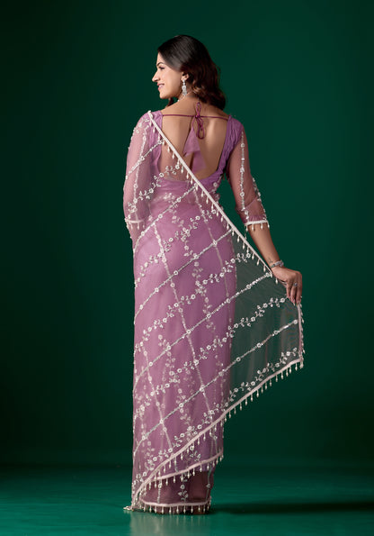 Purple net saree with intricate cutdana work by Kanyaari, featuring elegant drape and detailed embellishments.