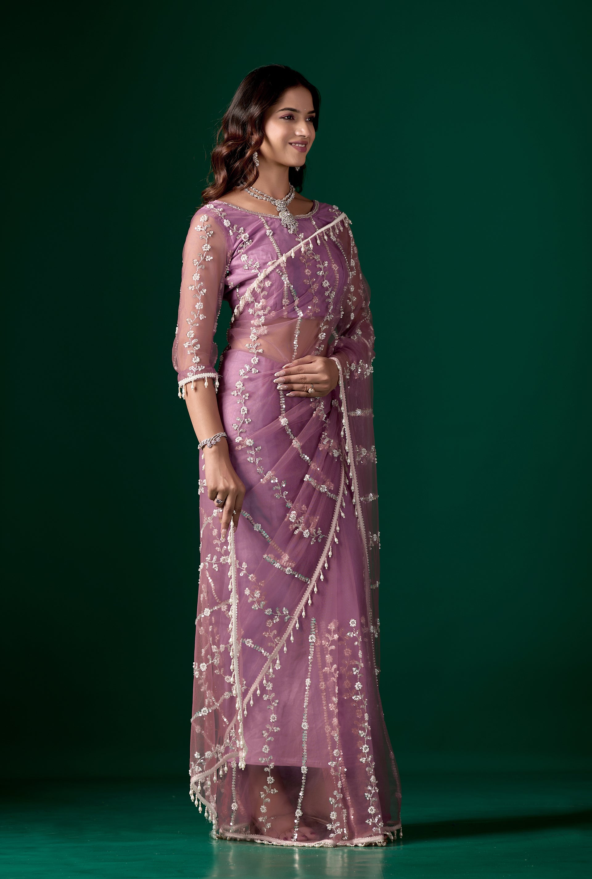 Purple net saree with intricate cutdana work by Kanyaari, featuring elegant draping and detailed embroidery.