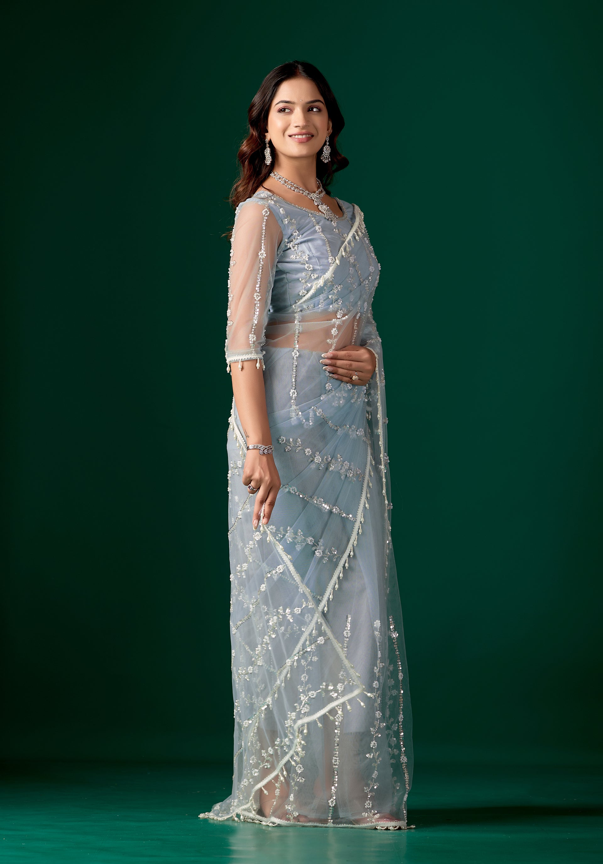 Sky blue net saree with cutdana work by Kanyaari, showcasing intricate embroidery and flowing fabric.