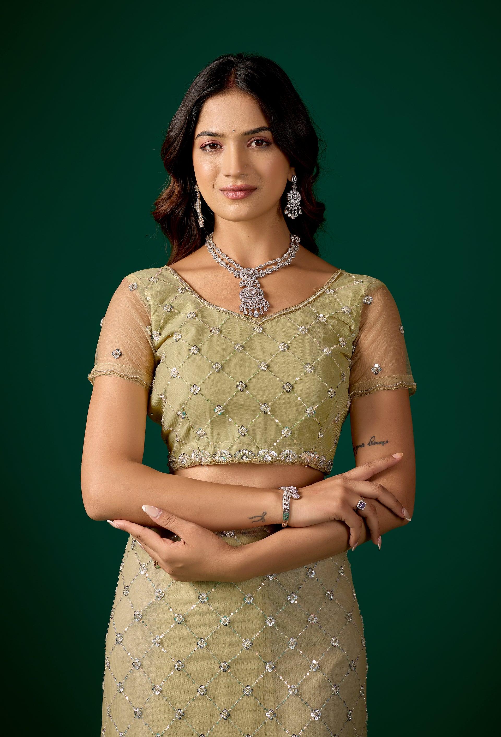 Kanyaari green net saree with cross stylish design and intricate cutdana work, showcasing elegant traditional Indian attire.