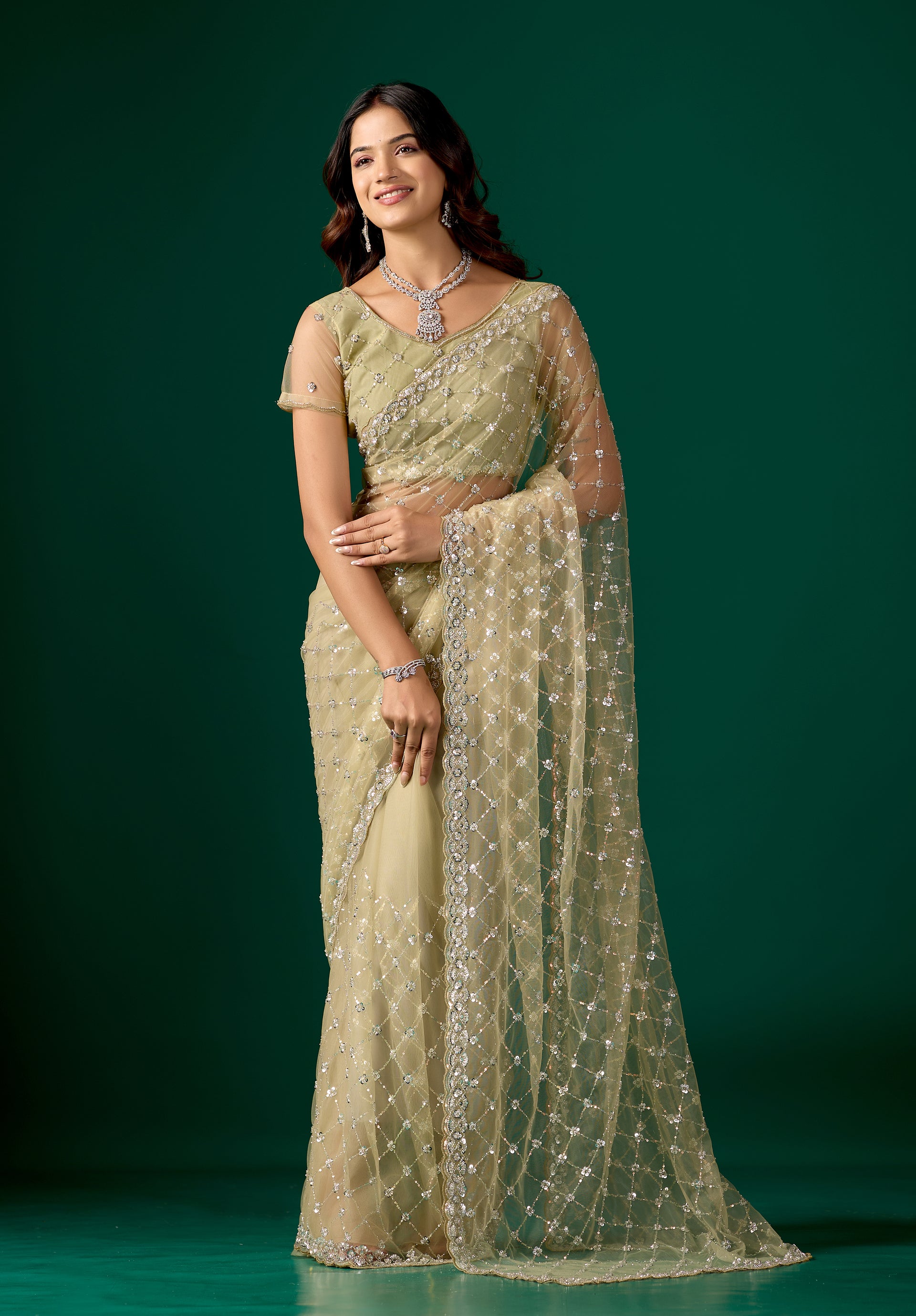 Green net saree with cutdana work, stylish design by Kanyaari, featuring intricate embroidery and draped fabric.