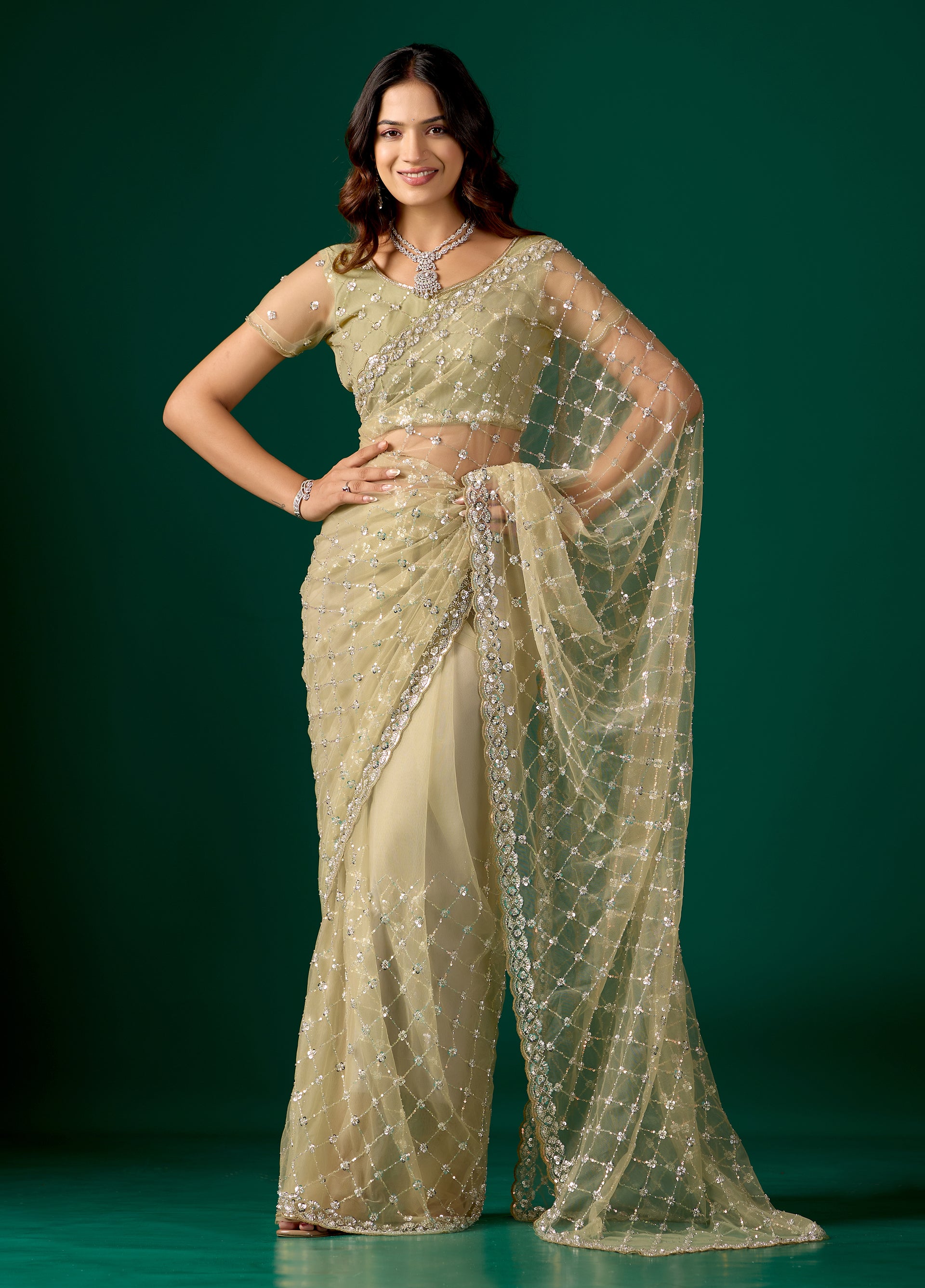 Green net saree with cutdana work from Kanyaari, featuring intricate embroidery and stylish design for elegant traditional wear.