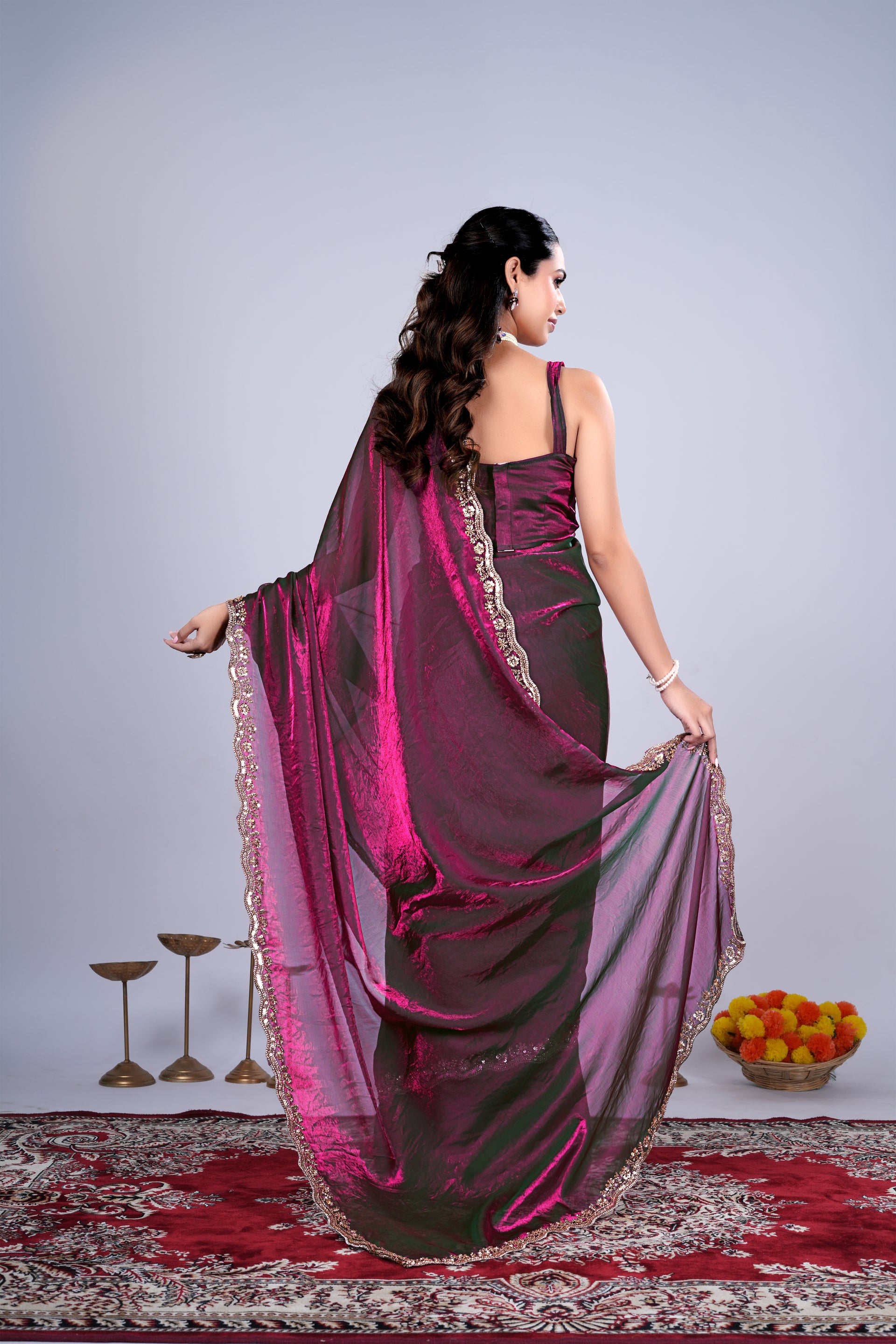 Wine-colored Kriti saree by Kanyaari featuring intricate cutdana work, draped elegantly with detailed craftsmanship.
