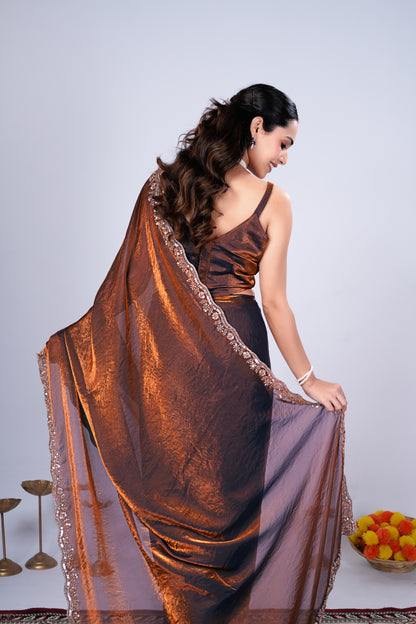 Kanyaari Kriti stylish brown saree with intricate cutdana work, showcasing elegant draping and detailed embroidery.