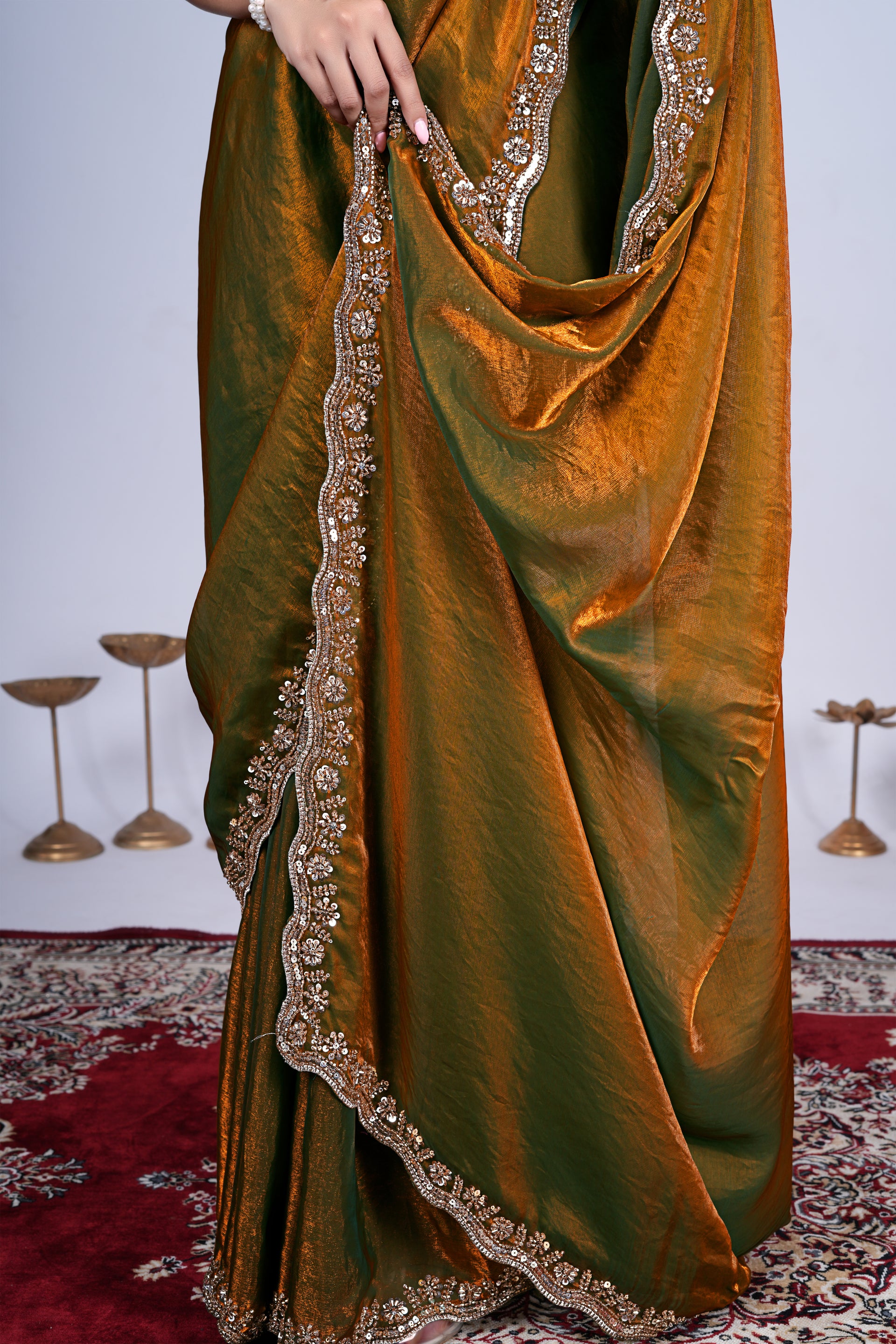 Kriti stylish saree in mehndi color with intricate cutdana work by Kanyaari, displayed with draped fabric and detailed embroidery.