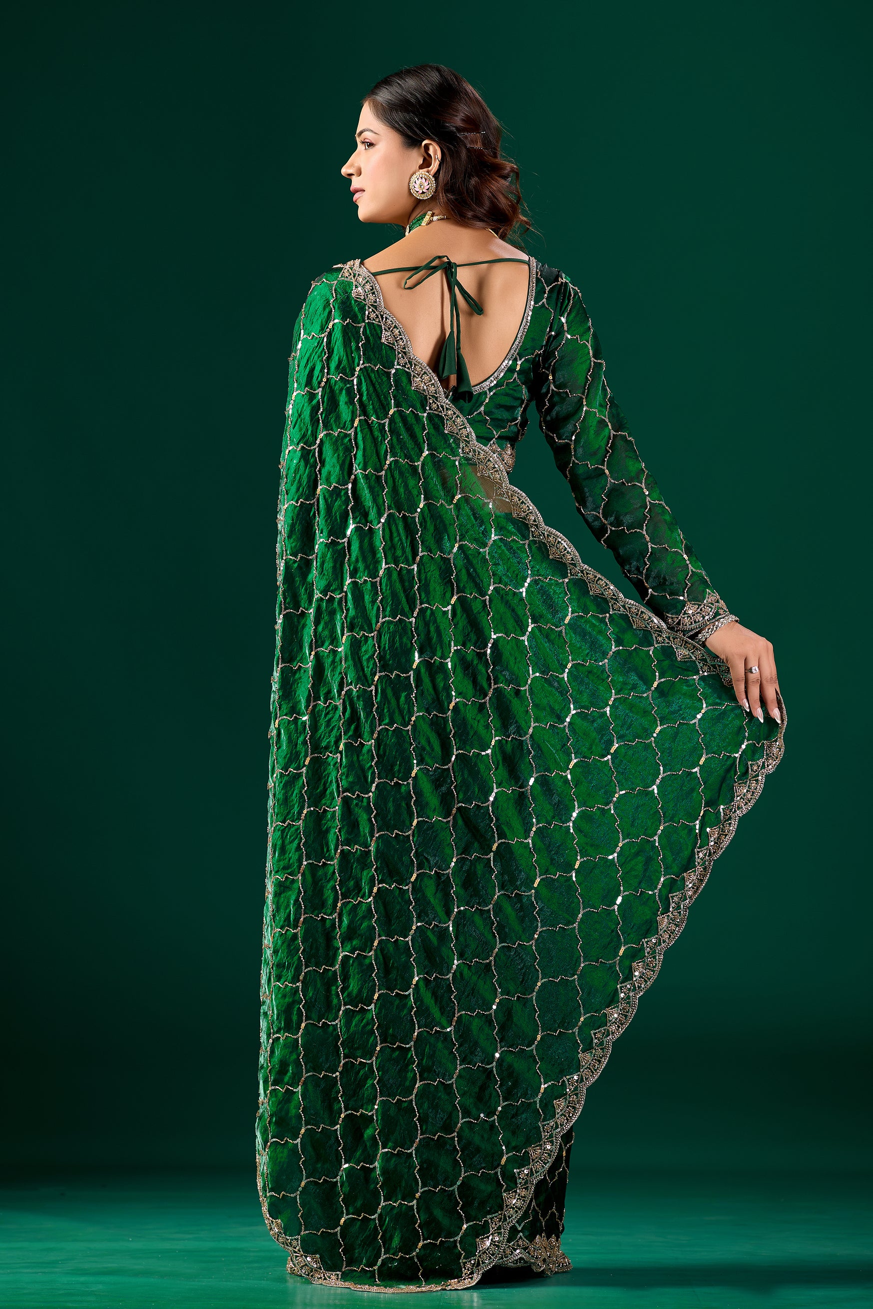 Green silk saree with rose gold cutdana work from Kanyaari's Barsana collection, featuring intricate embroidery and elegant drape.