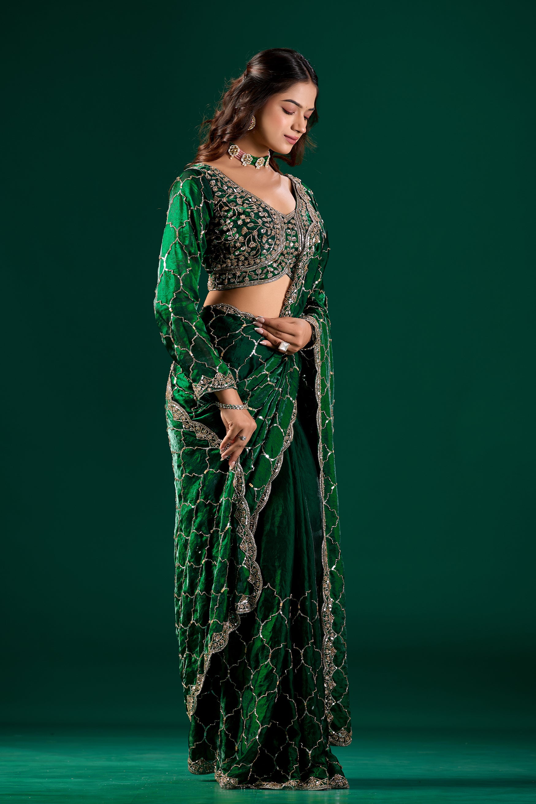 Elegant green silk saree with rose gold cutdana work from Kanyaari's Barsana collection, featuring intricate embroidery and traditional design.