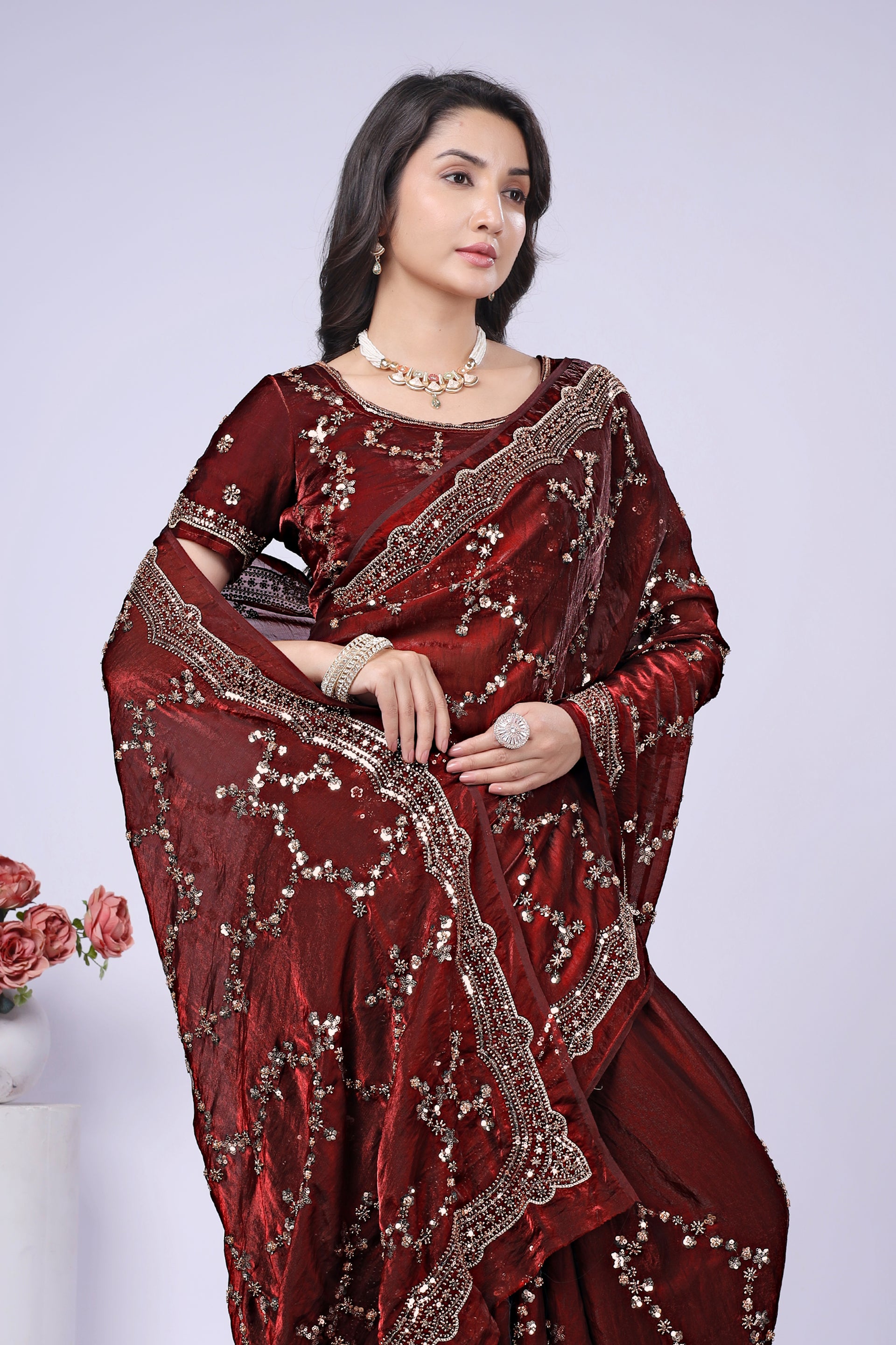 Maroon silk saree by Kanyaari with rose gold cutdana embroidery, intricate traditional design, and elegant drape.