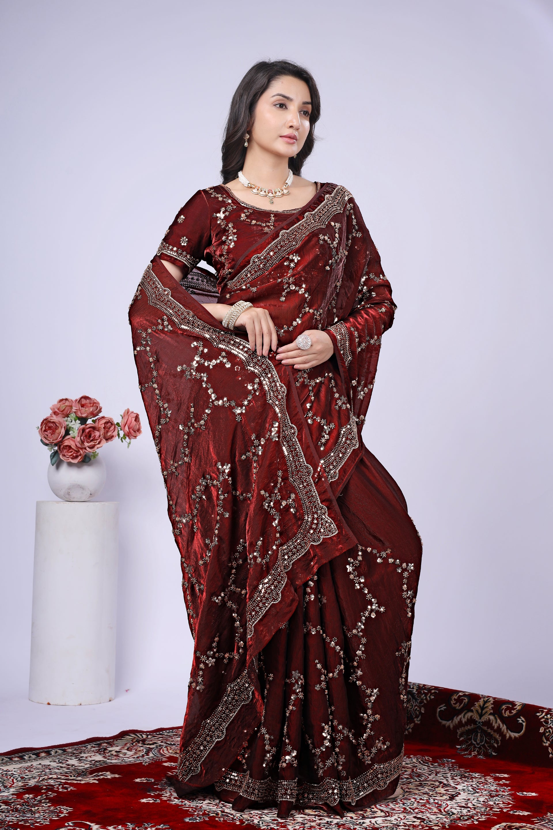 Maroon silk saree with rose gold cutdana work from Kanyaari, showcasing intricate embroidery and elegant draping.