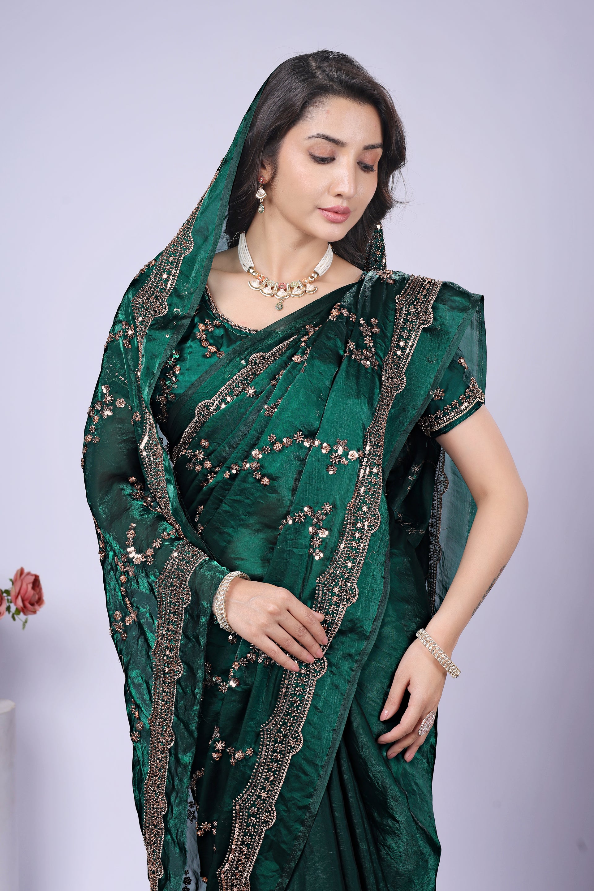 Dark green silk saree by Kanyaari featuring rose gold cutdana work, showcasing elegant craftsmanship and intricate embroidery.