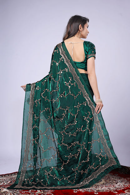 Dark green silk saree with rose gold cutdana work by Kanyaari, featuring intricate embroidery and elegant drape.
