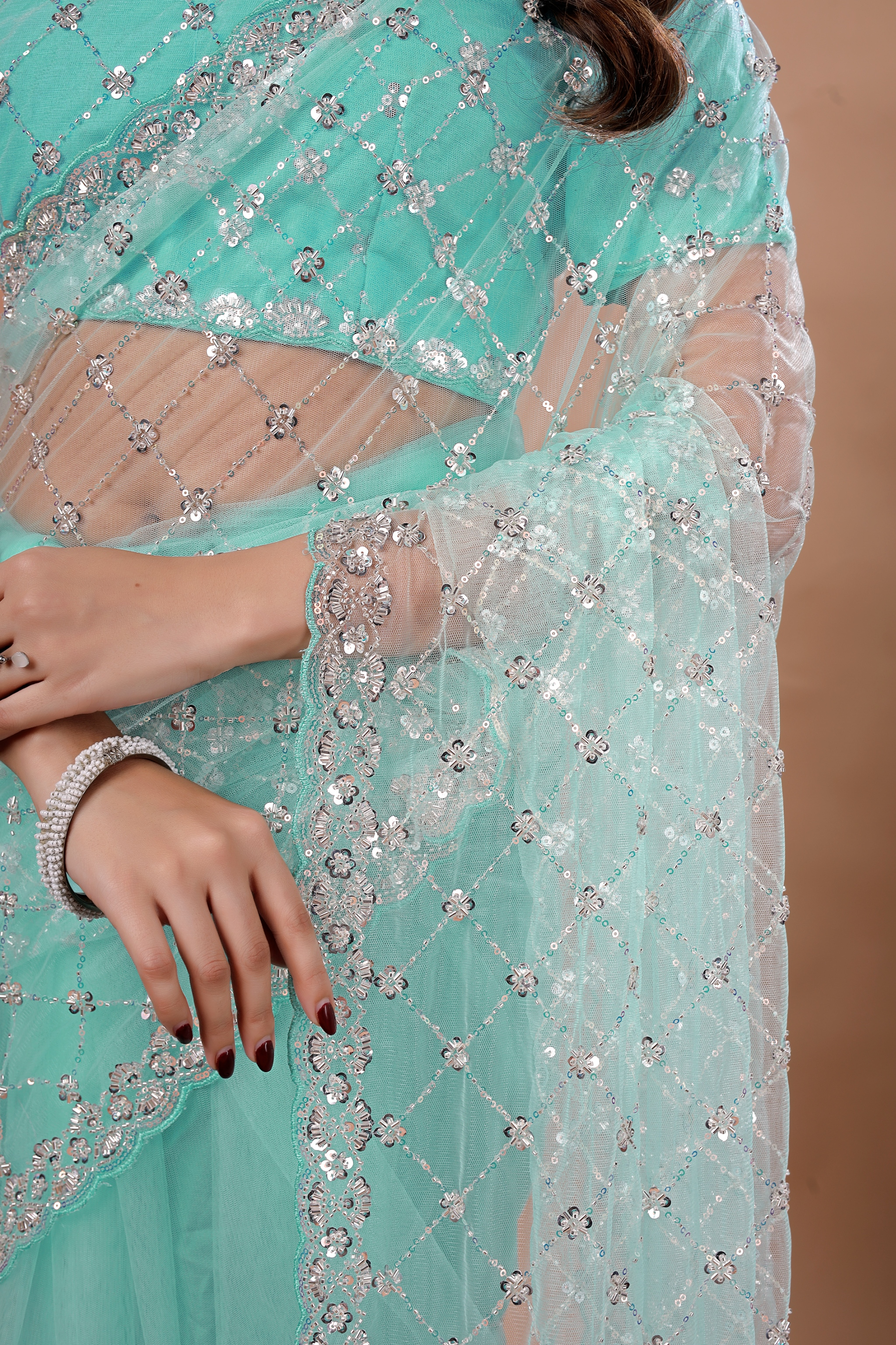 Blue party wear saree with intricate Cutdana work from Kanyaari, featuring elegant draping and detailed embellishments.