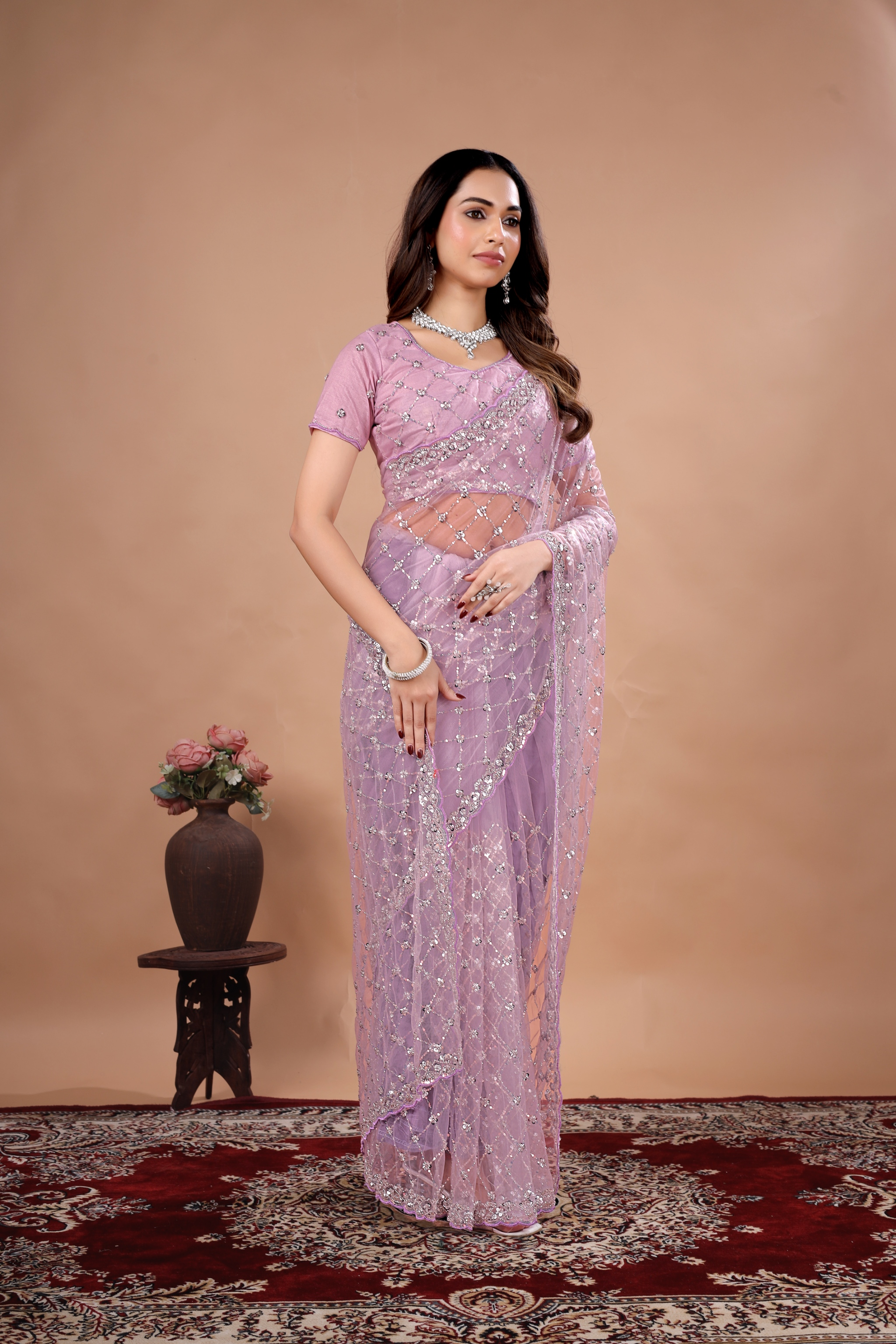 Lavender party wear saree with intricate cutdana work from Kanyaari, showcasing elegant drape and detailed embroidery.