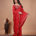 Red silk saree with rose gold cutdana embroidery by Kanyaari, featuring intricate design and elegant drape.