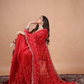 Red silk saree with rose gold cutdana work by Kanyaari, featuring intricate embroidery and luxurious drape.