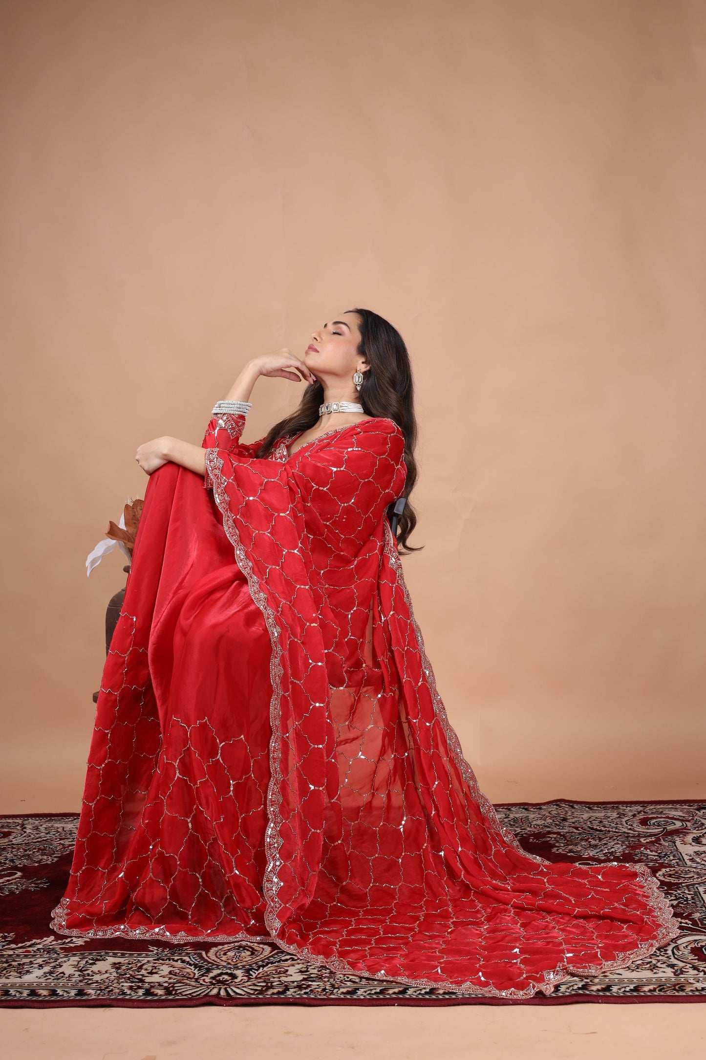 Red silk saree with rose gold cutdana work by Kanyaari, featuring intricate embroidery and luxurious drape.