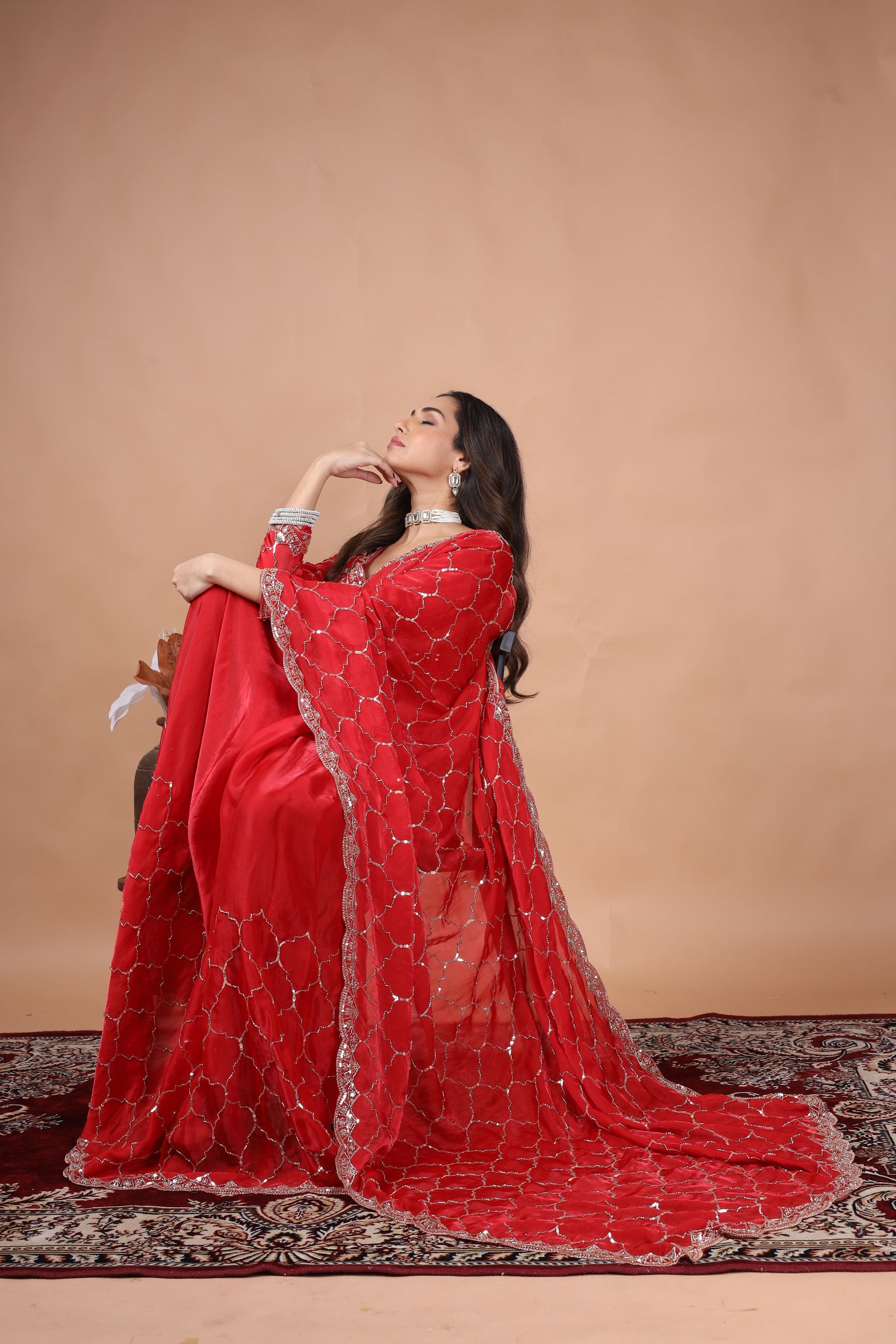 Red silk saree with rose gold cutdana work by Kanyaari, featuring intricate embroidery and luxurious drape.