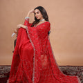 Red silk saree with rose gold cutdana work by Kanyaari, featuring intricate embellishments and traditional designs.
