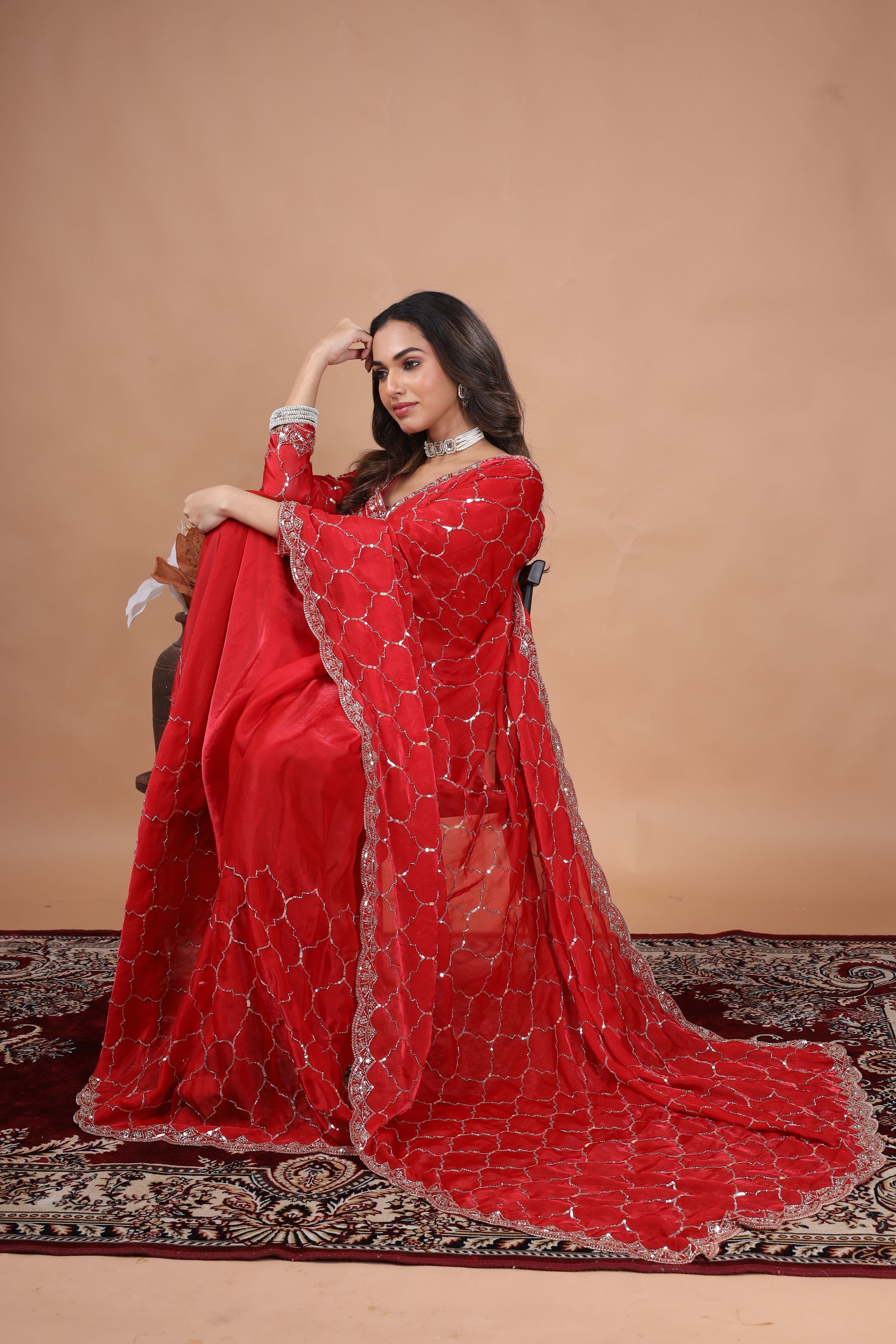 Red silk saree with rose gold cutdana work by Kanyaari, featuring intricate embellishments and traditional designs.