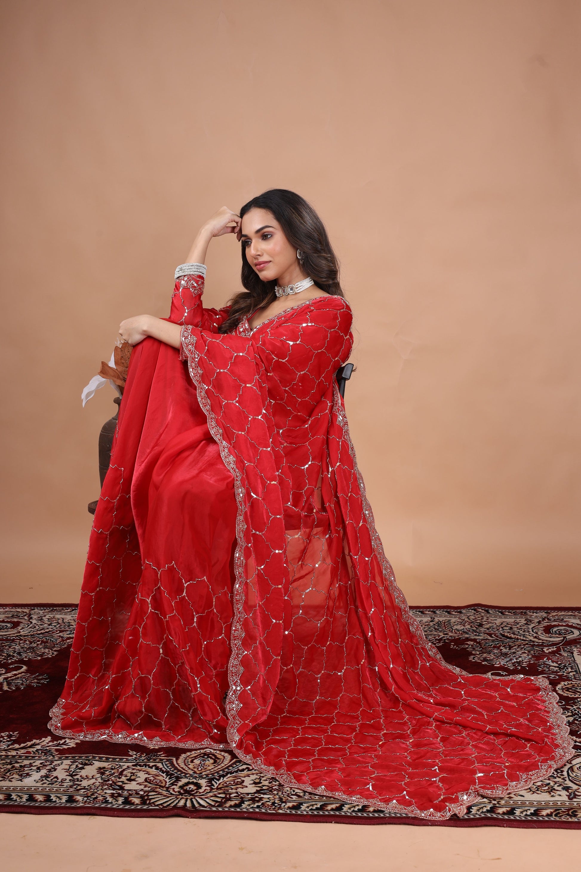 Red silk saree with rose gold cutdana work by Kanyaari, featuring intricate embellishments and traditional designs.