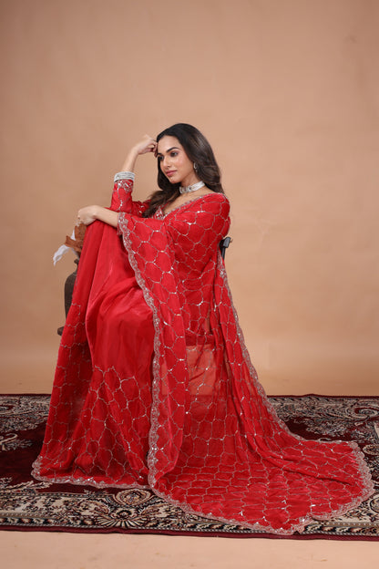 Red silk saree with rose gold cutdana work by Kanyaari, featuring intricate embellishments and traditional designs.