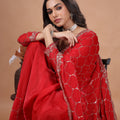 Red silk saree with rose gold cutdana work by Kanyaari, featuring intricate embroidery and elegant draping.