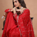 Red silk saree with rose gold cutdana work from Kanyaari, featuring intricate embroidery and traditional Indian design.