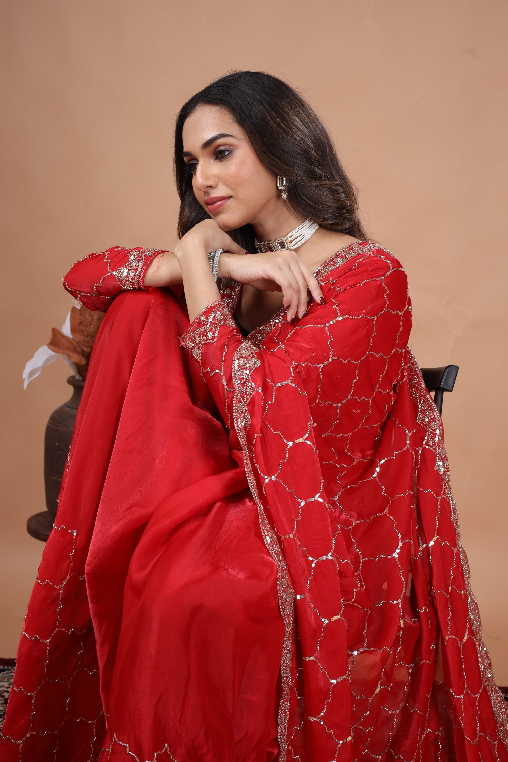 Red silk saree with rose gold cutdana work from Kanyaari, featuring intricate embroidery and traditional Indian design.