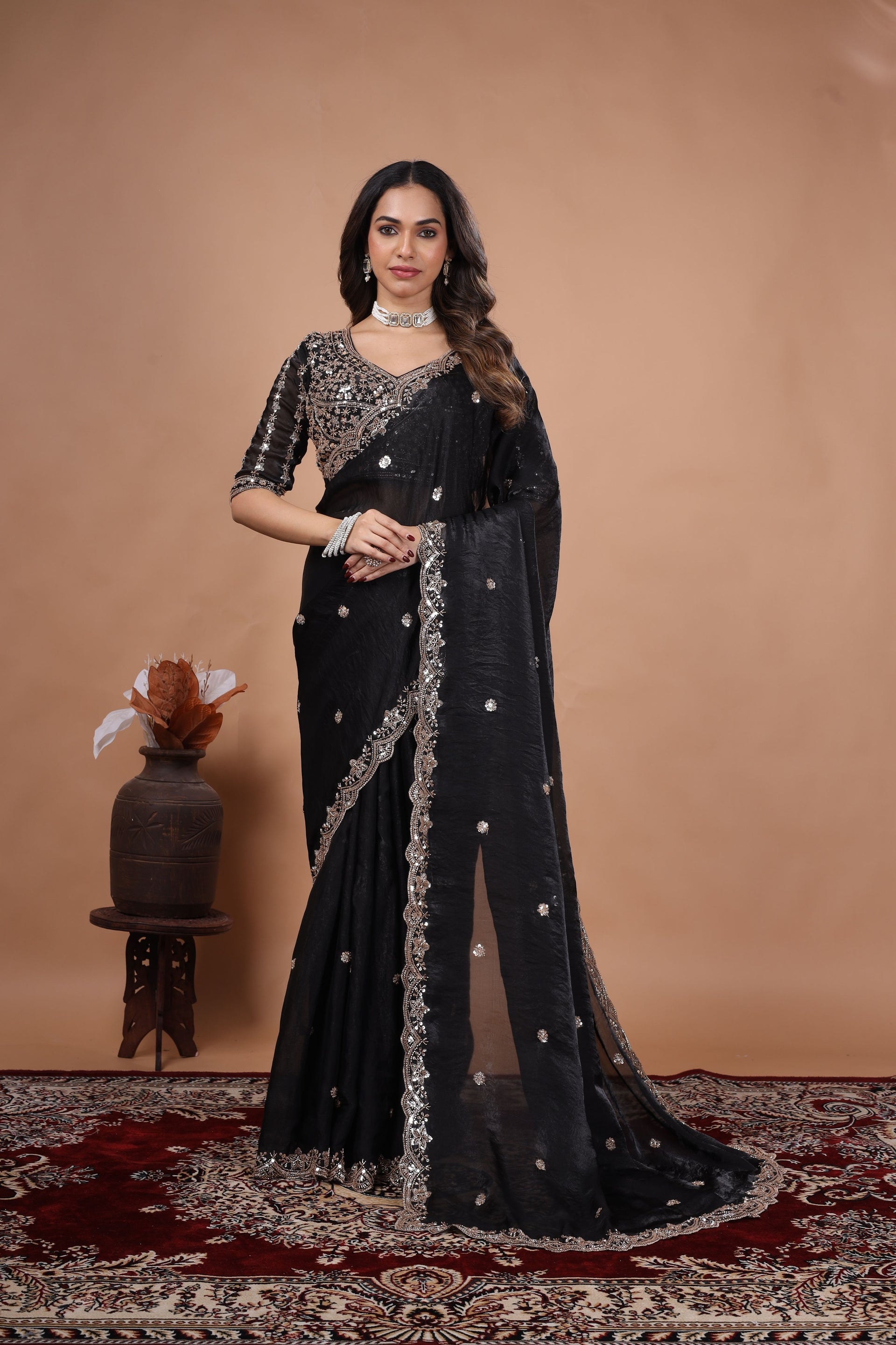 Black heavy saree with cutdana work by Kanyaari, featuring intricate embroidery and traditional design details.