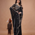 Black heavy saree with cutdana work from Kanyaari featuring intricate embroidery and traditional design, worn draped elegantly.