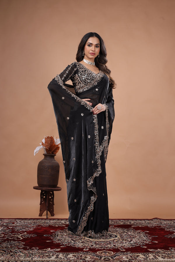 Black heavy saree with cutdana work from Kanyaari featuring intricate embroidery and traditional design, worn draped elegantly.