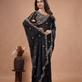 Black heavy saree with cutdana work from Kanyaari, featuring intricate embroidery and traditional craftsmanship.