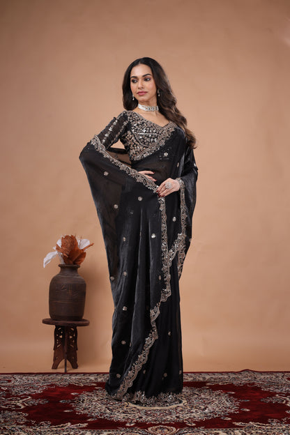 Black heavy saree with cutdana work from Kanyaari, featuring intricate embroidery and traditional craftsmanship.