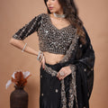 Black heavy saree with cutdana work by Kanyaari, featuring intricate embellishments and traditional design.