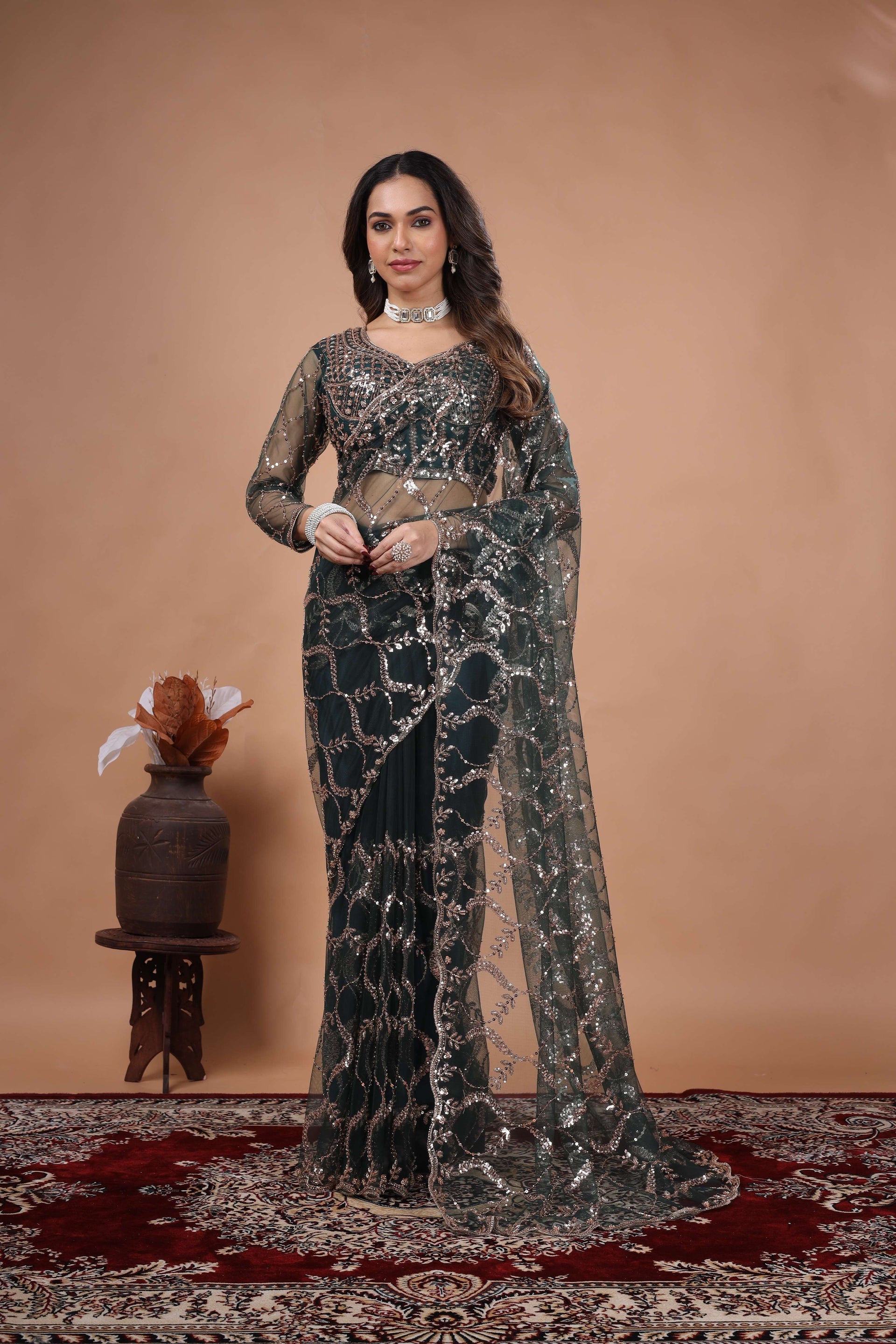 Green net saree with heavy cutdana work border by Kanyaari, showcasing intricate embroidery and elegant draping.