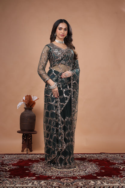 Green net saree by Kanyaari with heavy cutdana work border, showcasing intricate embroidery and elegant drape design.