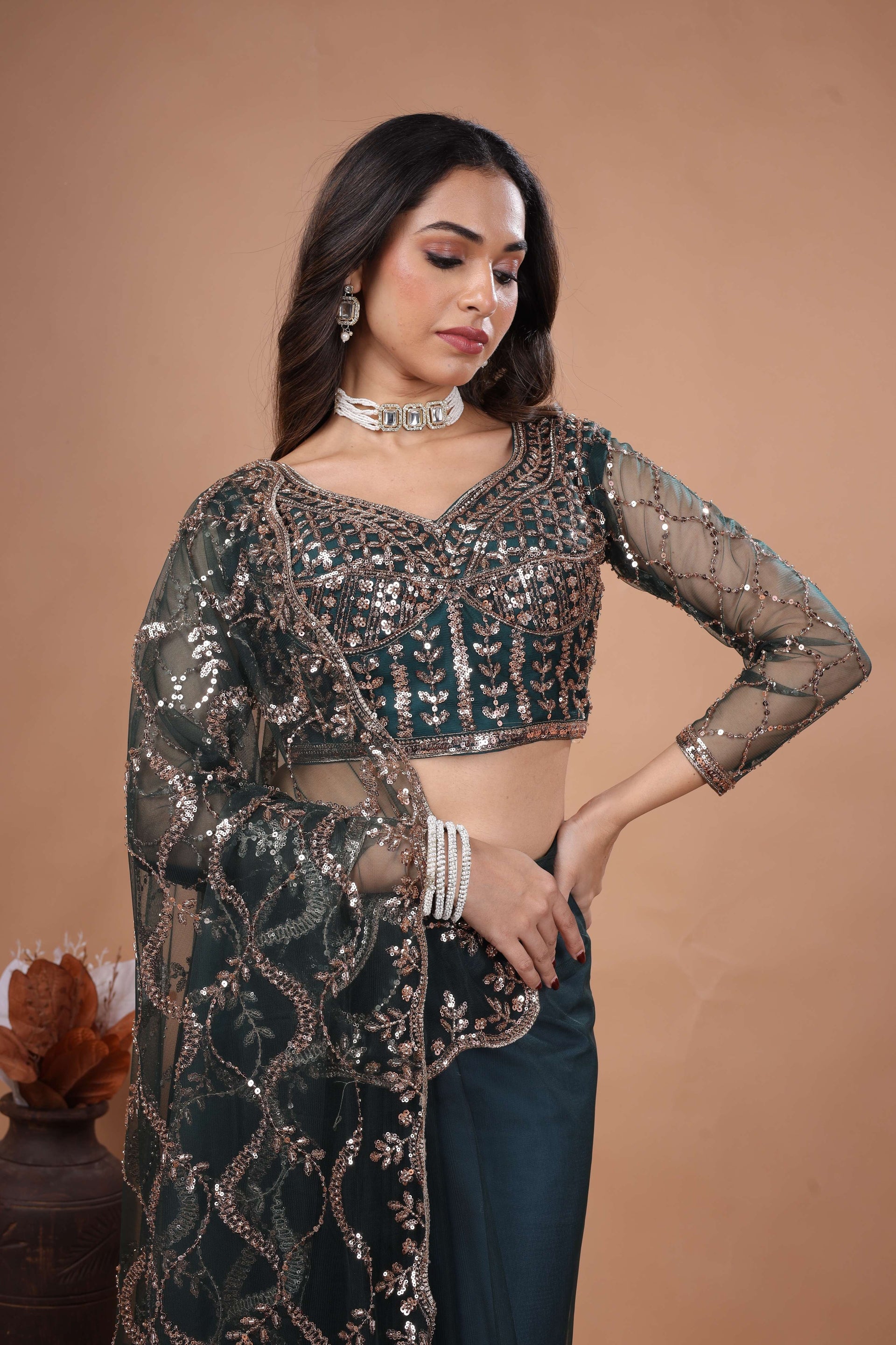 Green net saree with heavy cutdana work border by Kanyaari, showcasing intricate embroidery and elegant drape.