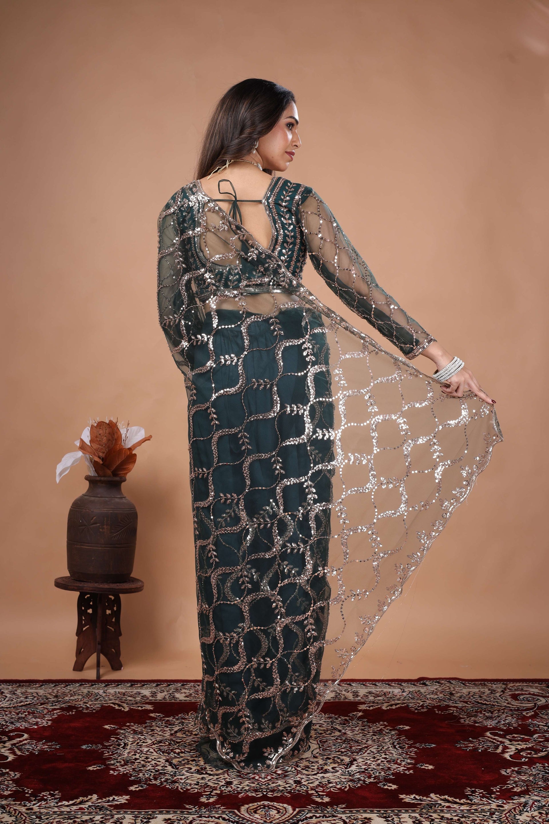 Green net saree with heavy cutdana work border by Kanyaari, showcasing intricate embroidery and elegant drape.