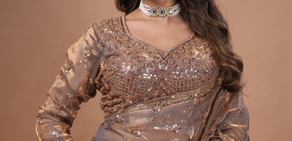 Elegant silk saree with rose gold cutdana work and gold detailing by Kanyaari, showcasing intricate craftsmanship and luxurious fabric.