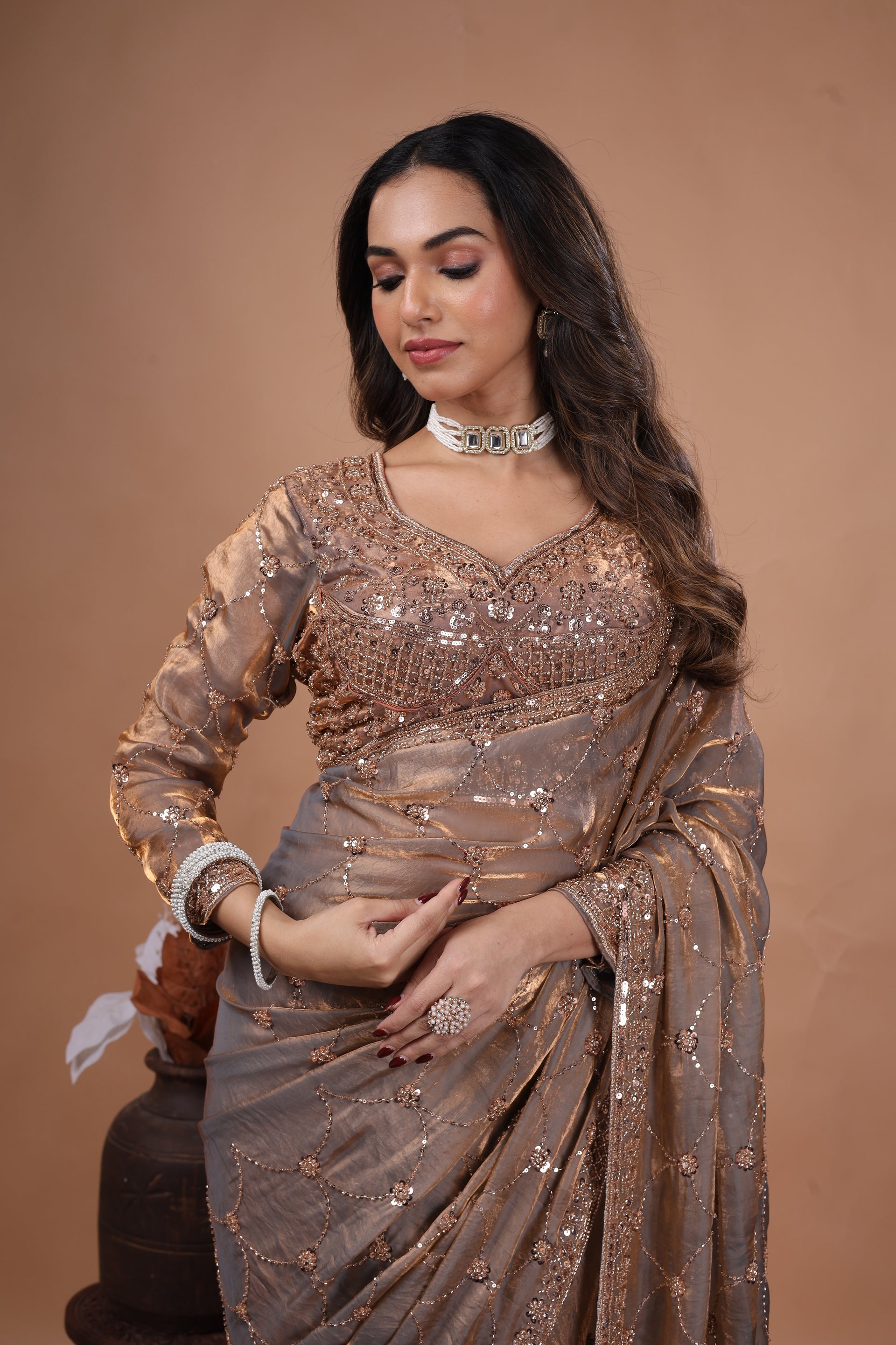 Kanyaari luxury silk saree with rose gold cutdana work, featuring intricate embroidery and elegant drape in a vibrant color.