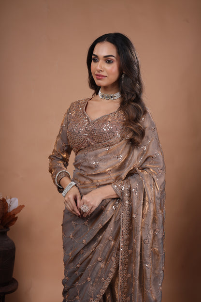 Kanyaari luxury silk saree with rose gold cutdana work, featuring intricate gold embellishments and elegant drape.