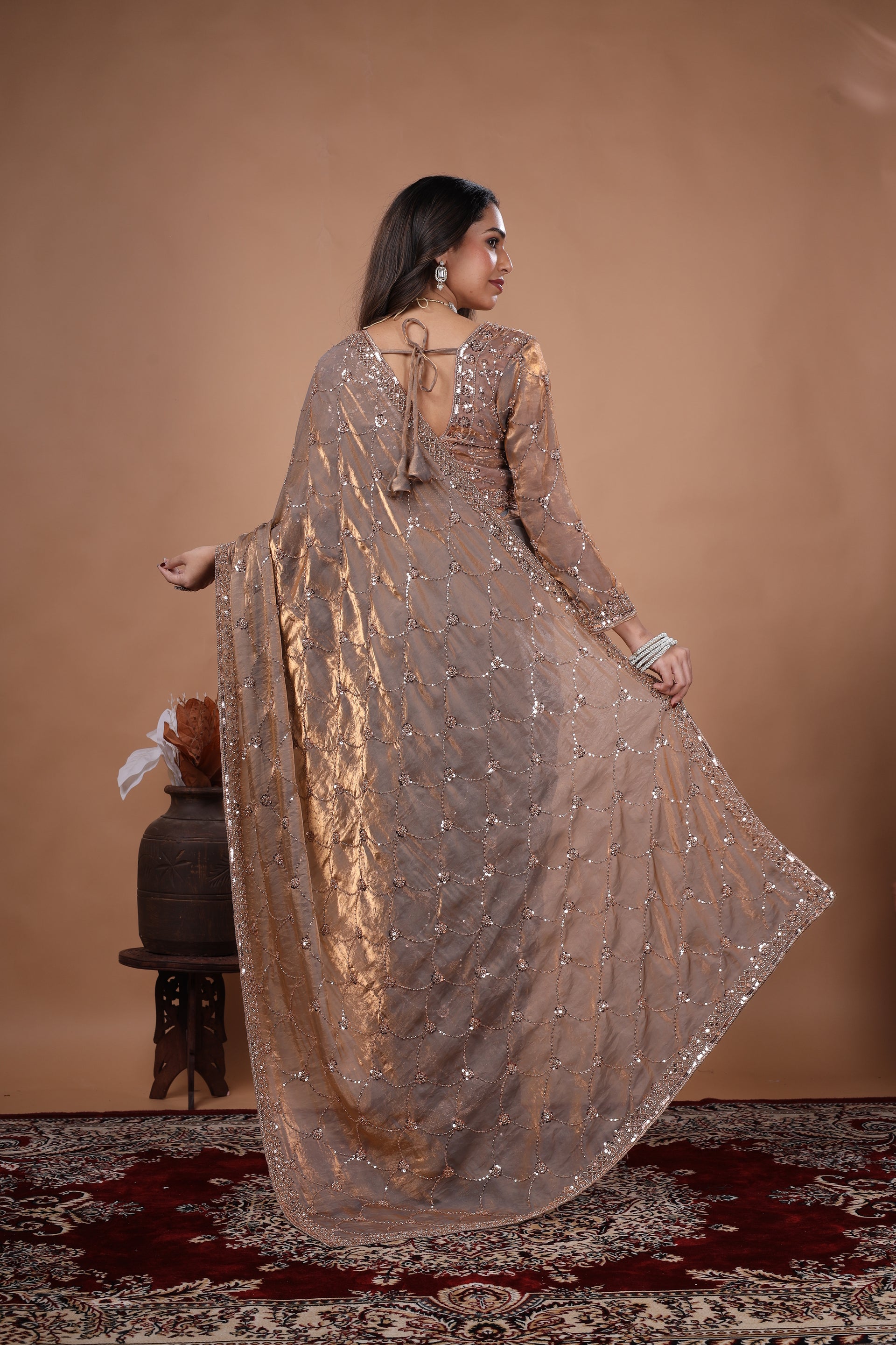 Elegant silk saree with rose gold cutdana work by Kanyaari, featuring intricate gold embroidery and luxurious fabric.
