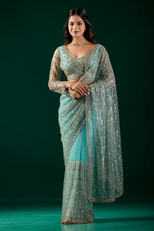Kanyaari blue saree with heavy cutdana embroidery and net fabric, featuring intricate design and traditional craftsmanship.