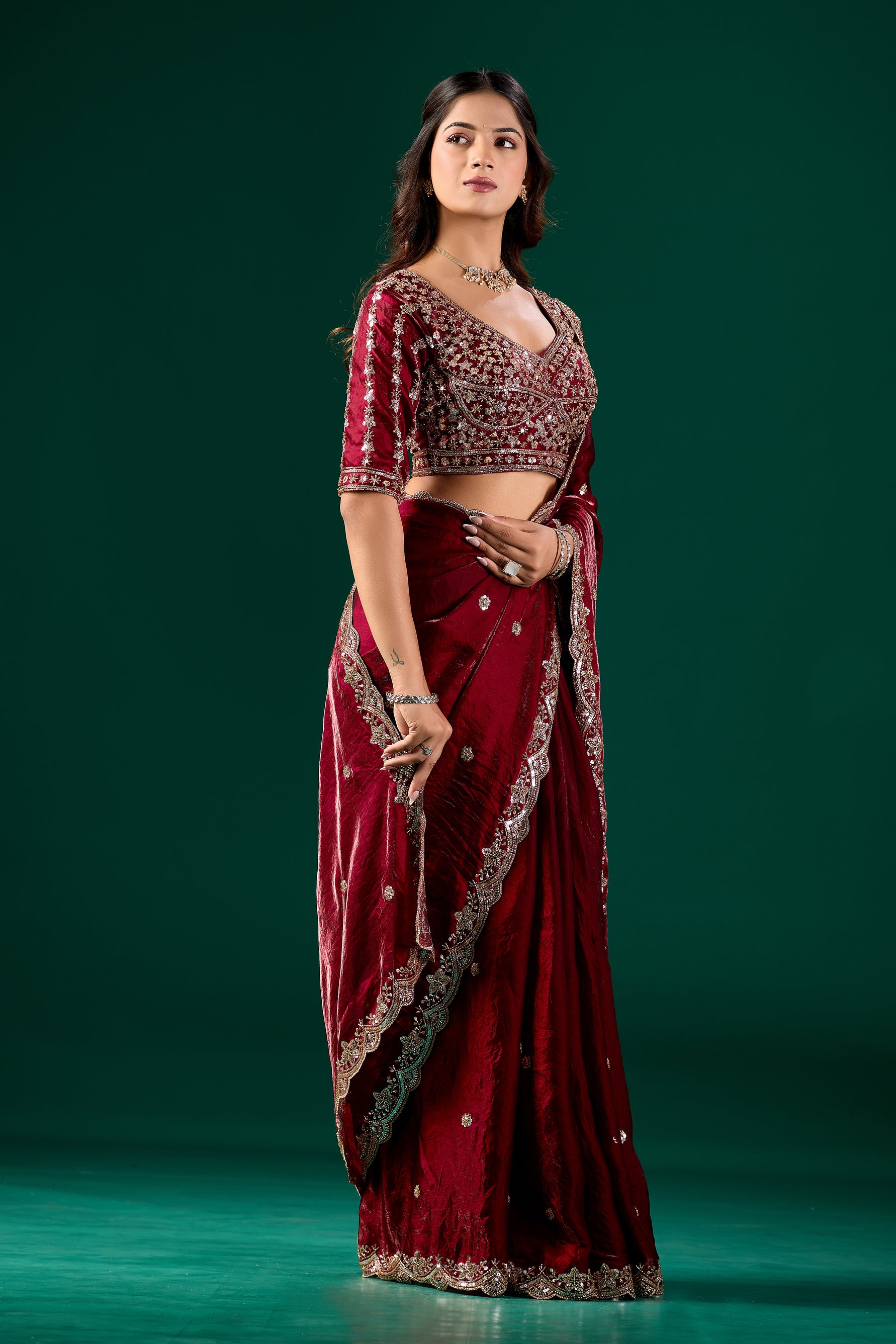 Maroon heavy saree with intricate cutdana work from Kanyaari, showcasing detailed embroidery and traditional design.