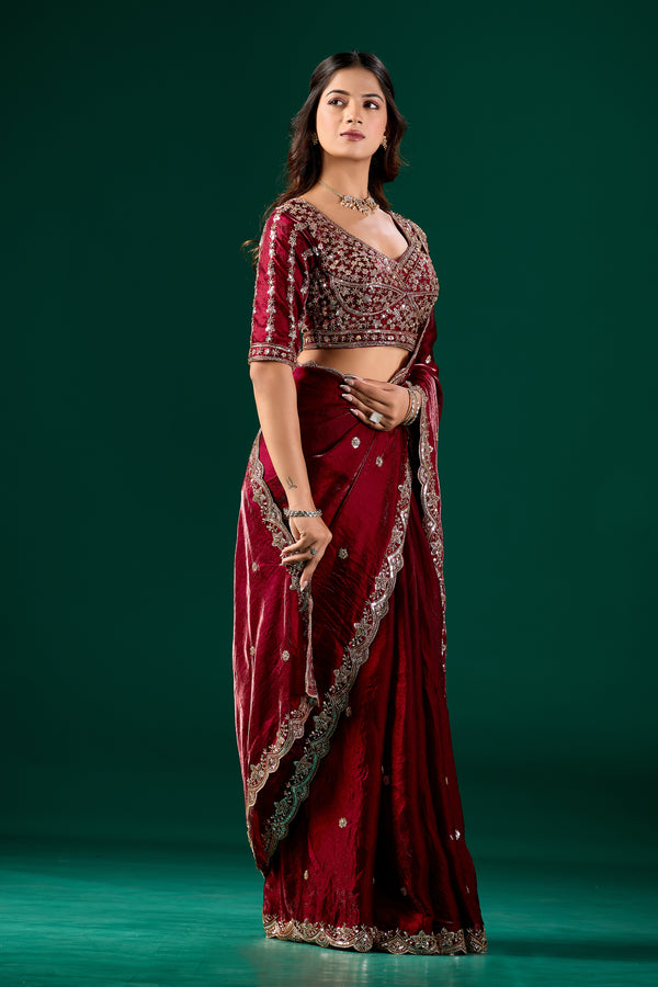 Maroon heavy saree with intricate cutdana work from Kanyaari, showcasing detailed embroidery and traditional design.