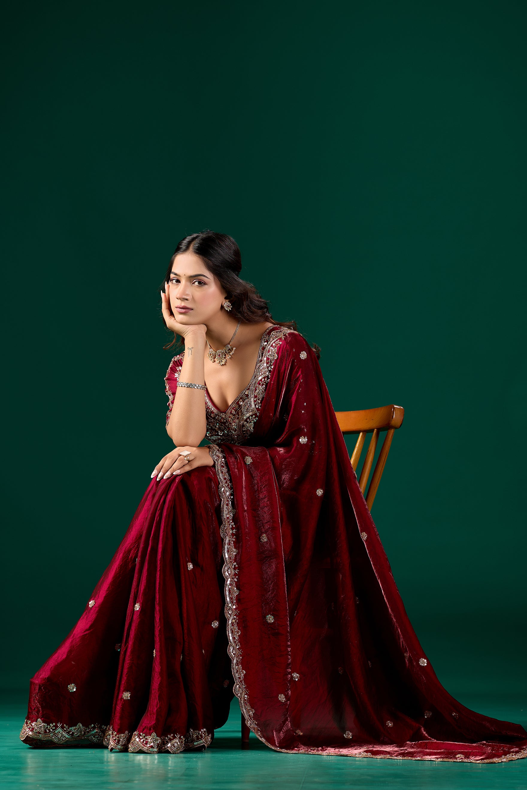 Maroon heavy saree with intricate cutdana work from Kanyaari, featuring detailed embroidery and traditional design.