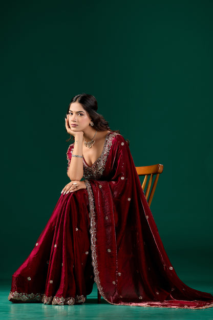 Maroon heavy saree with intricate cutdana work from Kanyaari, featuring detailed embroidery and traditional design.