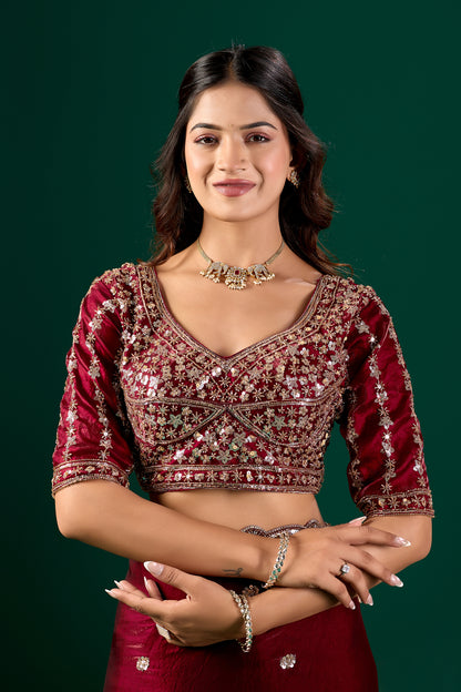 Heavy maroon saree with intricate cutdana work by Kanyaari, showcasing detailed embellishments and traditional elegance.