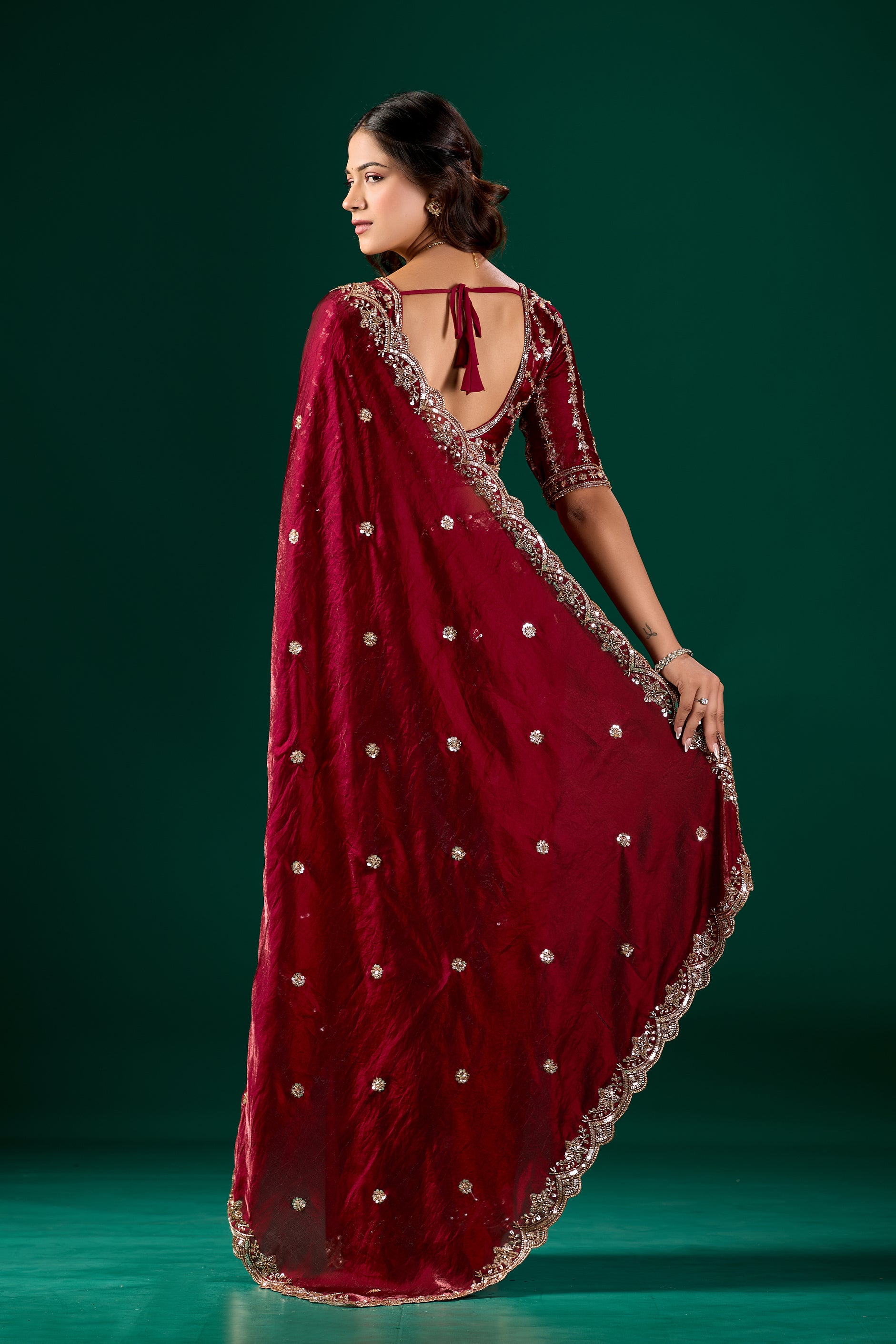 Maroon saree with detailed cutdana work from Kanyaari, showcasing intricate embroidery and elegant drape in the Full Heavy Nora saree.